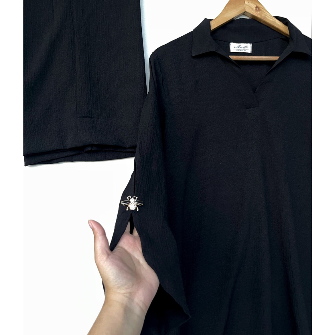 Dragonfly brooch detail on black textured georgette sleeve