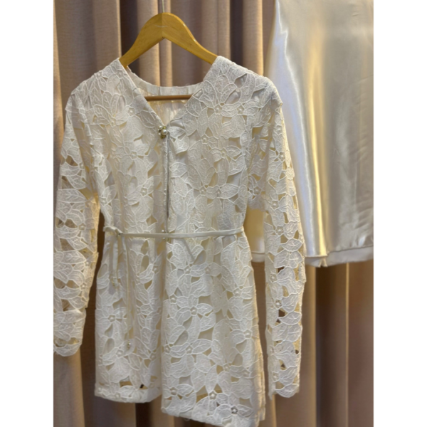 Off-white lace cutwork dress with pearl buttons and waist tie detail