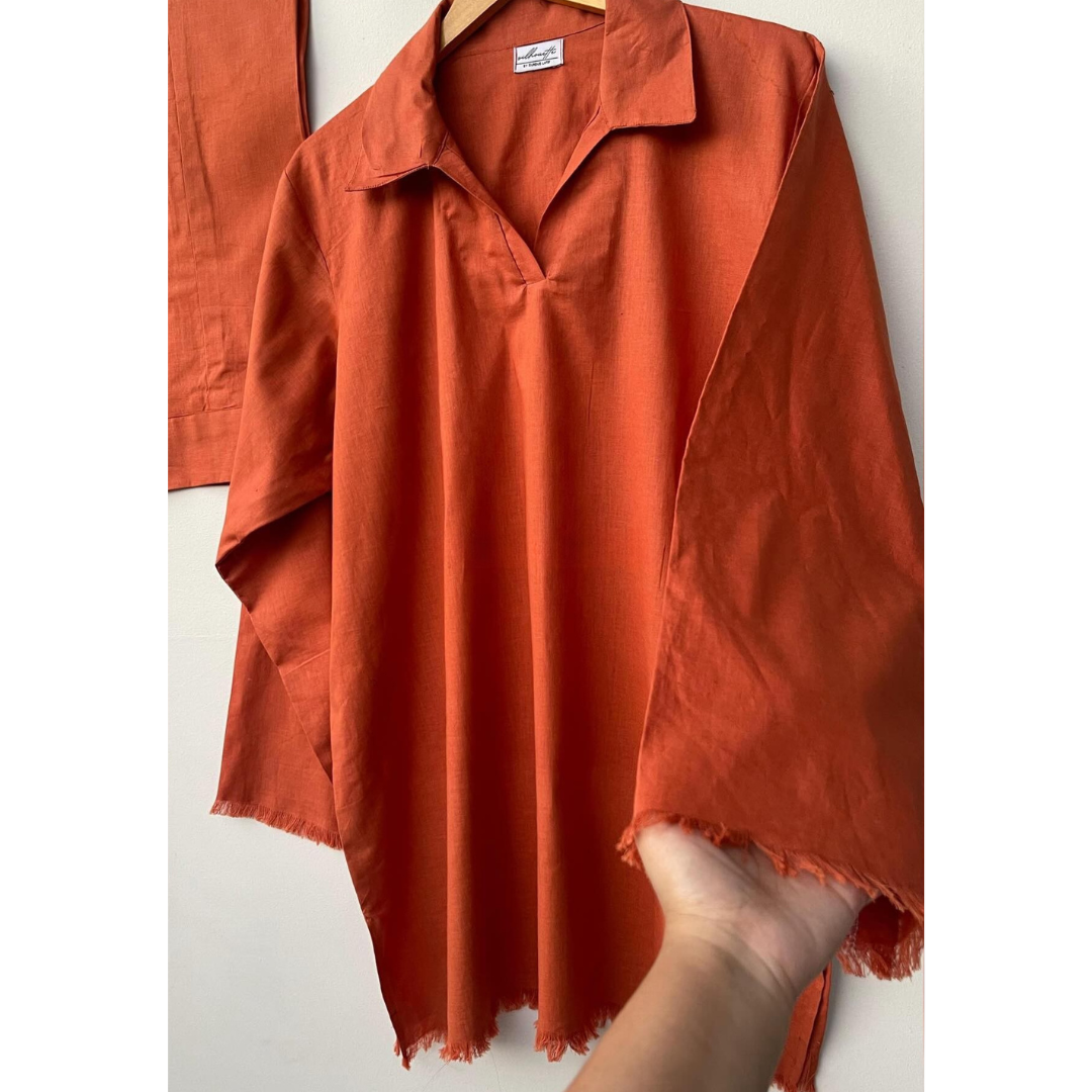 Frayed sleeve and hem detail on rust textured cotton shirt