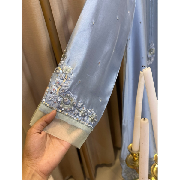 Close up of hand embroidered sleeve detail on Opal Elise pastel blue kaftan on Silhouette by SL